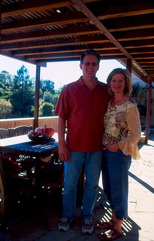 Mark and Karen stand beneath the covered walkway between their house and garage.
